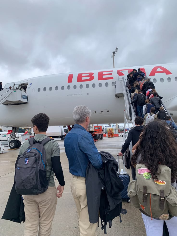 Travellers boarding an aircraft on the runway